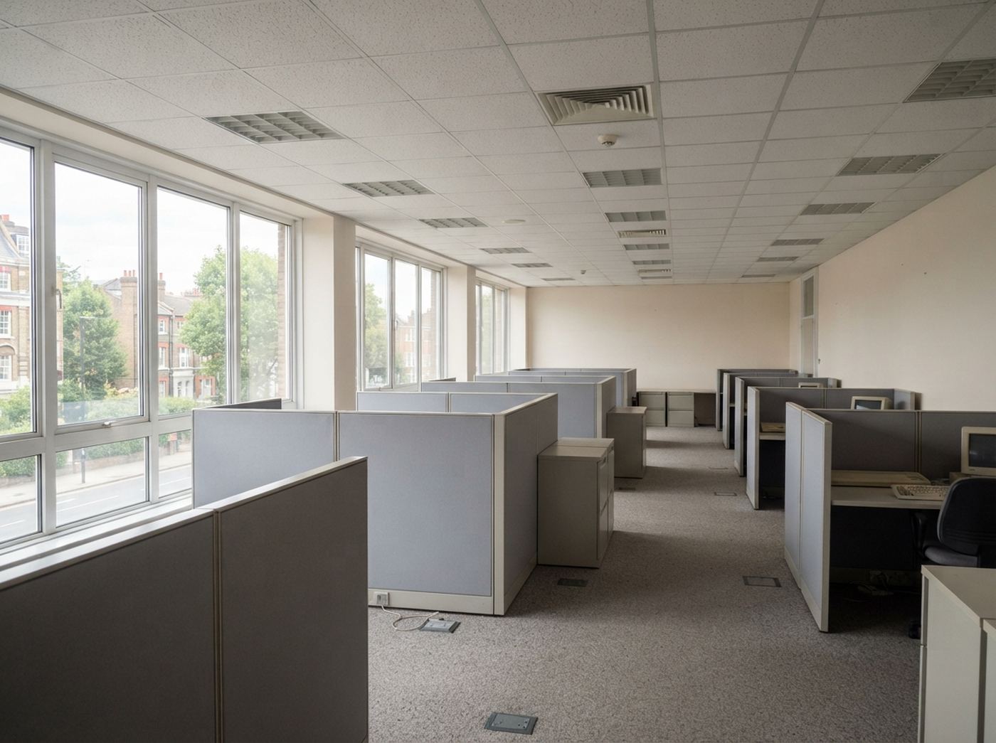 Interior of an older UK commercial building with suspended ceiling tiles and original fittings